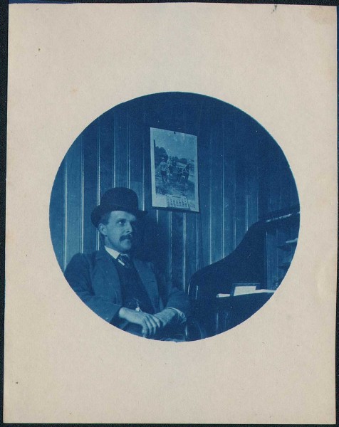 Man with Bowler hat at Desk