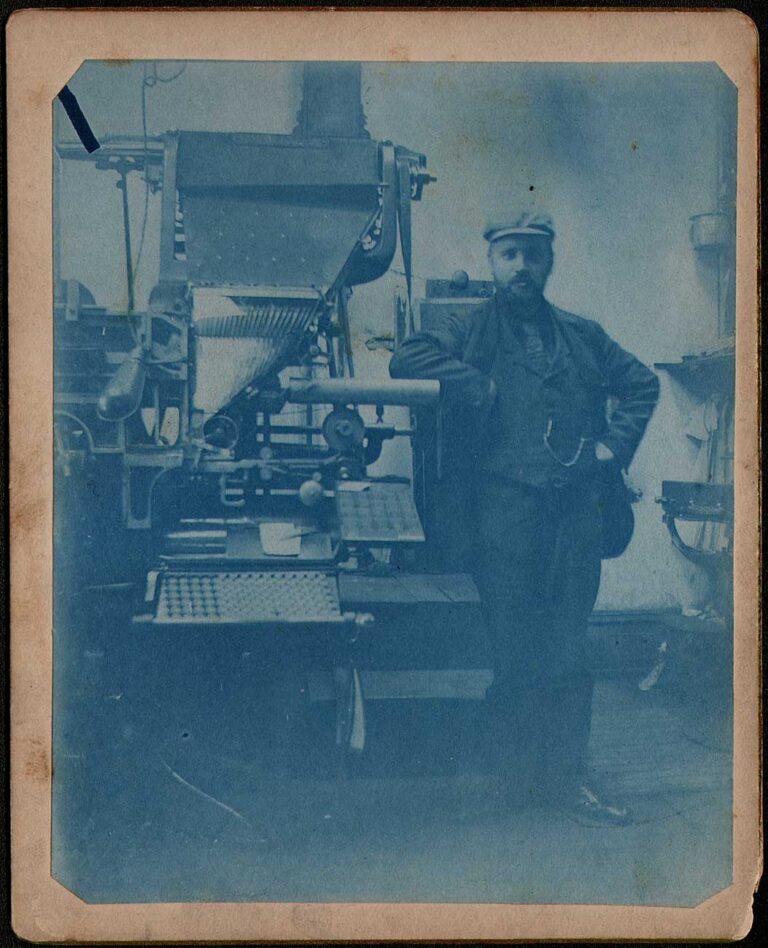 Man Standing Next to Linotype Machine