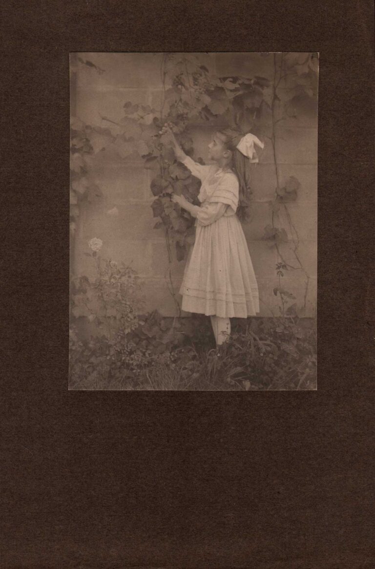 Dorothy Reaching for Grapes outside Home
