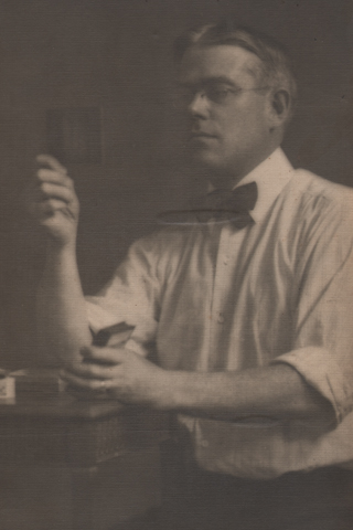 Man Holding & Inspecting Photographic Slides