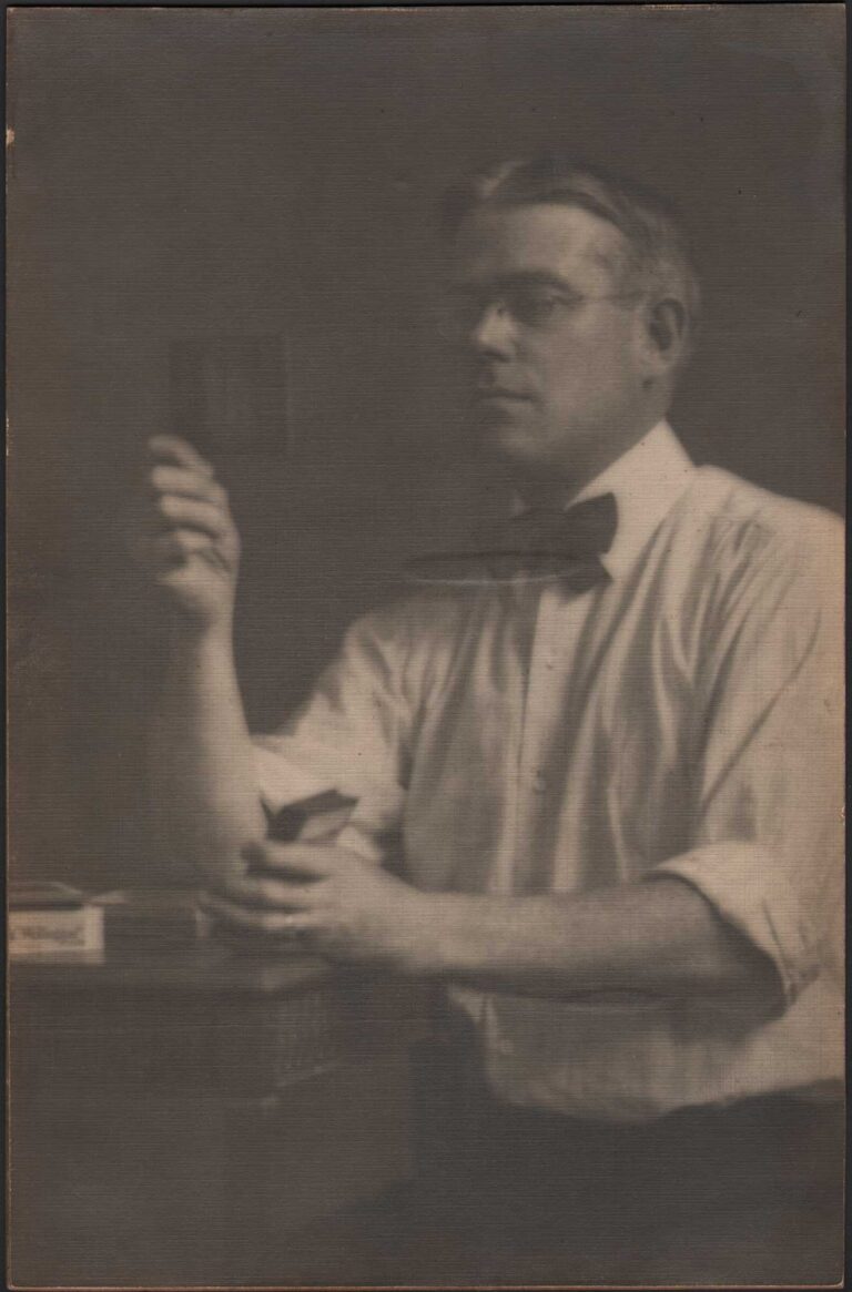 Man Holding & Inspecting Photographic Slides