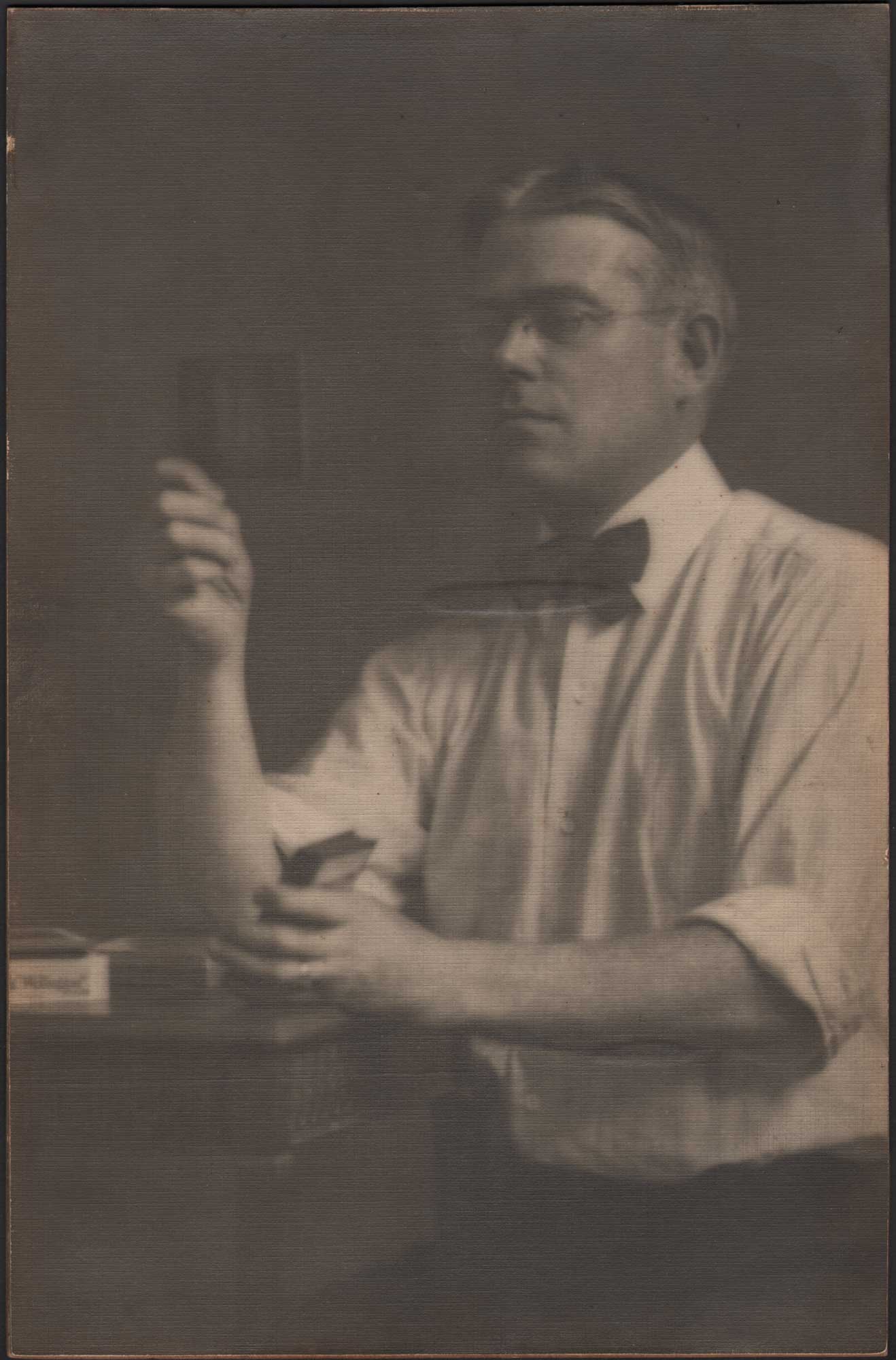 Man Holding & Inspecting Photographic Slides