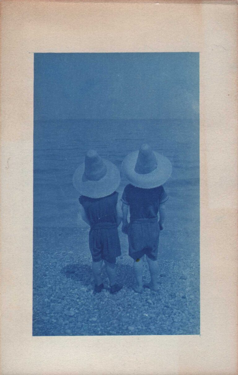 Children with Matching Straw Hats at Seashore