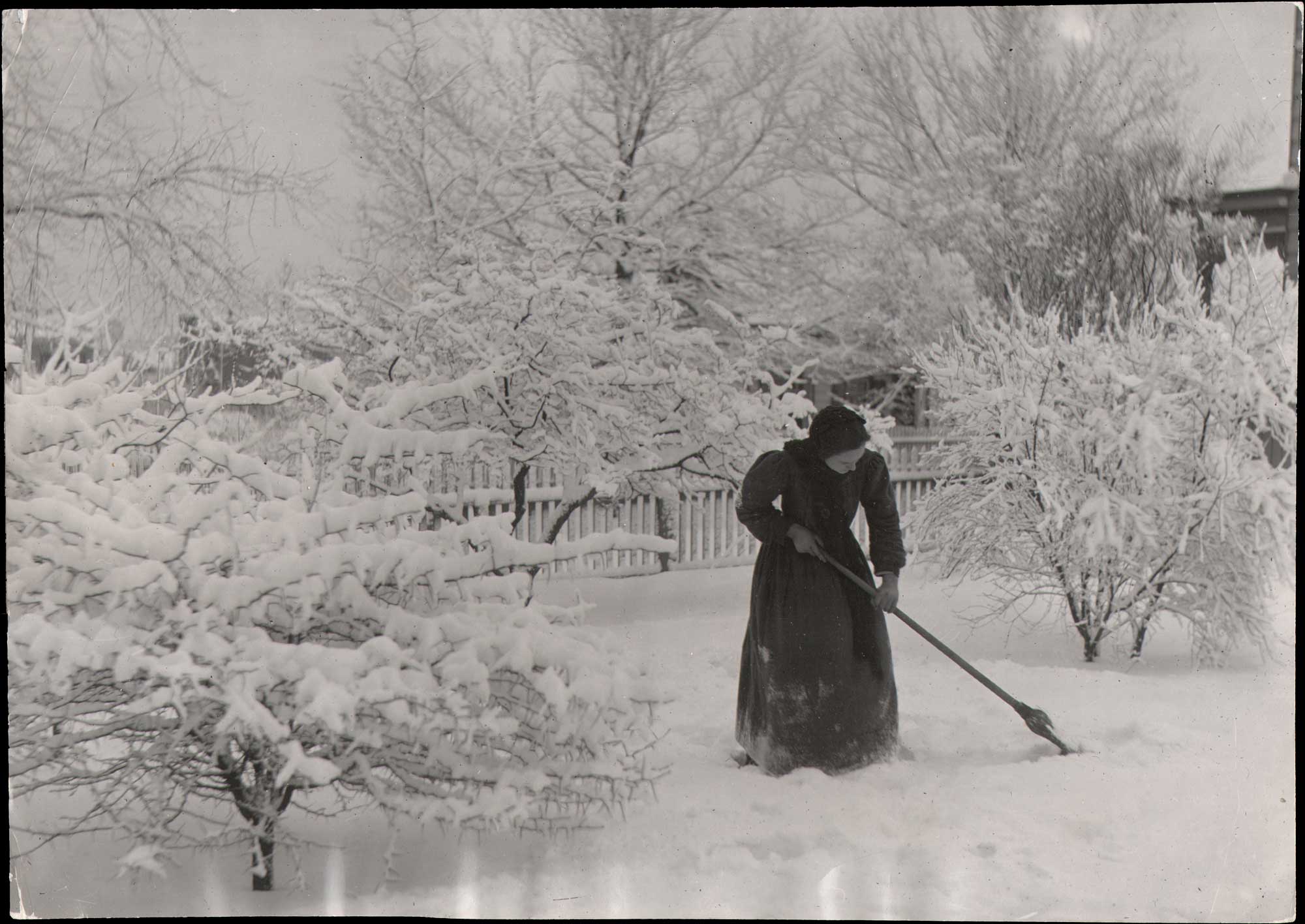 Minnie Fennel Sweeps Snow after Storm
