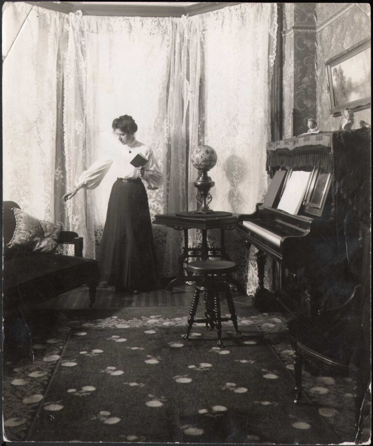 Minnie Fennel Holding Book in Parlor