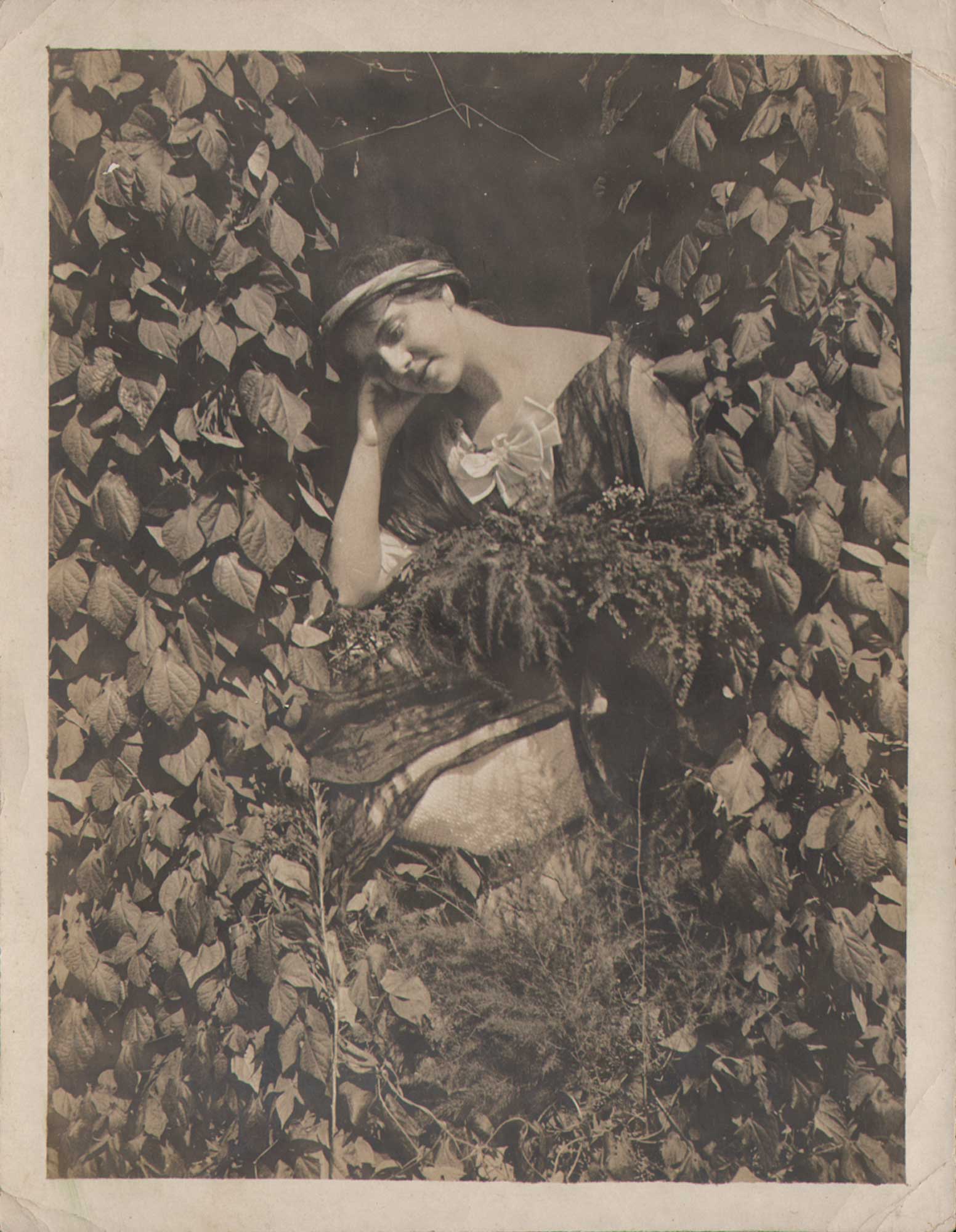 Contemplative Woman Surrounded by Plants