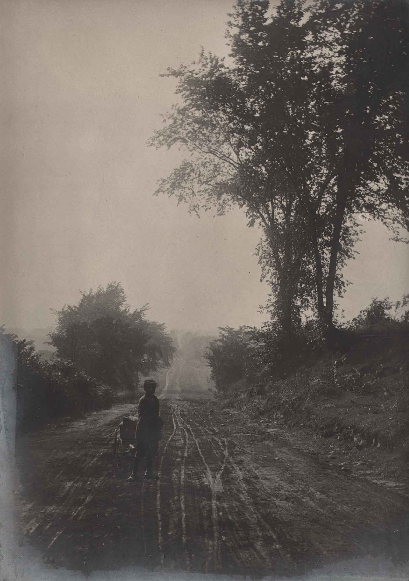 Boy Pulling Wagon on Dirt Road